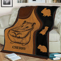 Hamster blanket styled across a couch, featuring a large illustrated hamster and warm brown tones