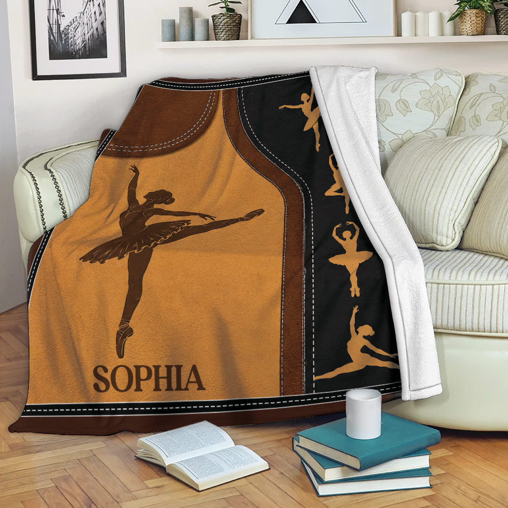 Ballet throw blanket draped over a sofa with graceful dancer silhouettes and warm theatrical colors