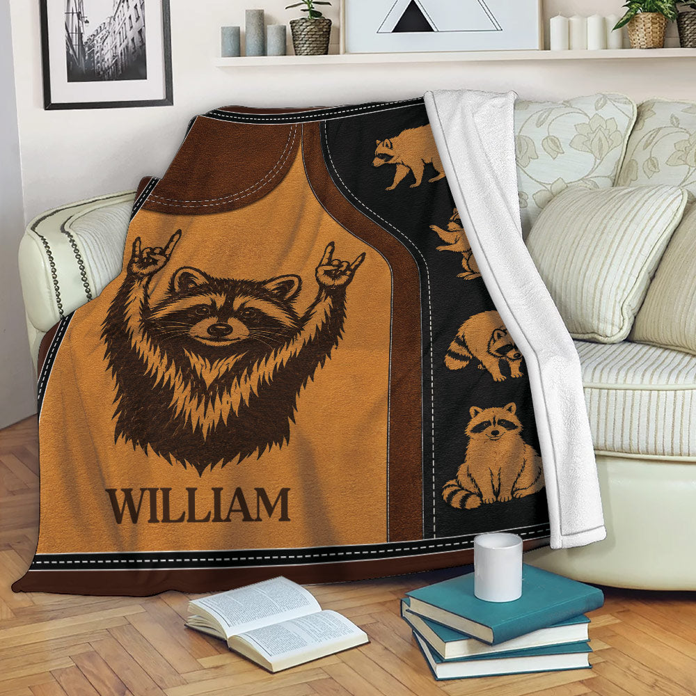 Raccoon throw blanket draped over a sofa with cozy woodland animal artwork