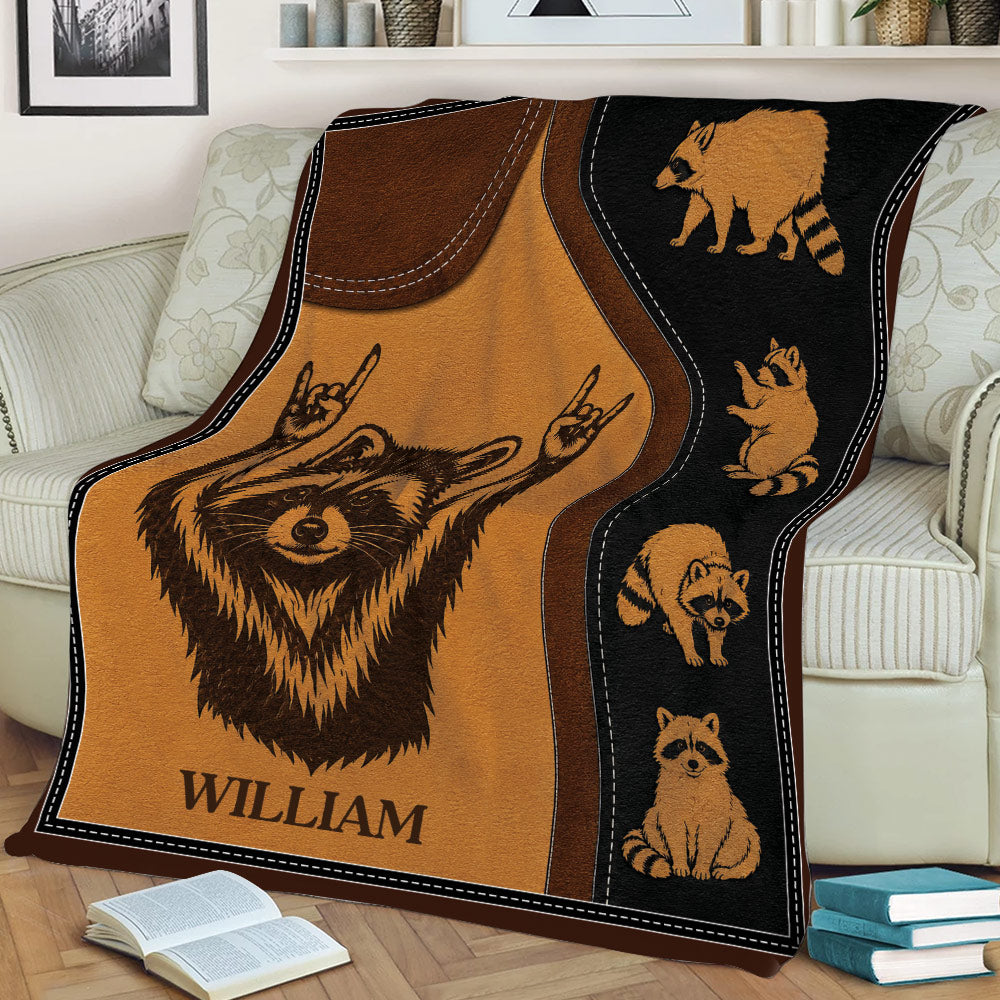 Raccoon blanket spread across a sofa featuring a large raccoon and coordinating raccoon illustrations