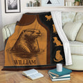 Otter throw blanket draped over a sofa with wildlife artwork and a cozy reading nook