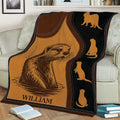 Otter blanket displayed across a sofa, featuring a large otter illustration and repeated silhouettes