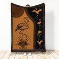 Custom flamingo blanket with golden flamingo artwork, stitched border details, and warm brown tones