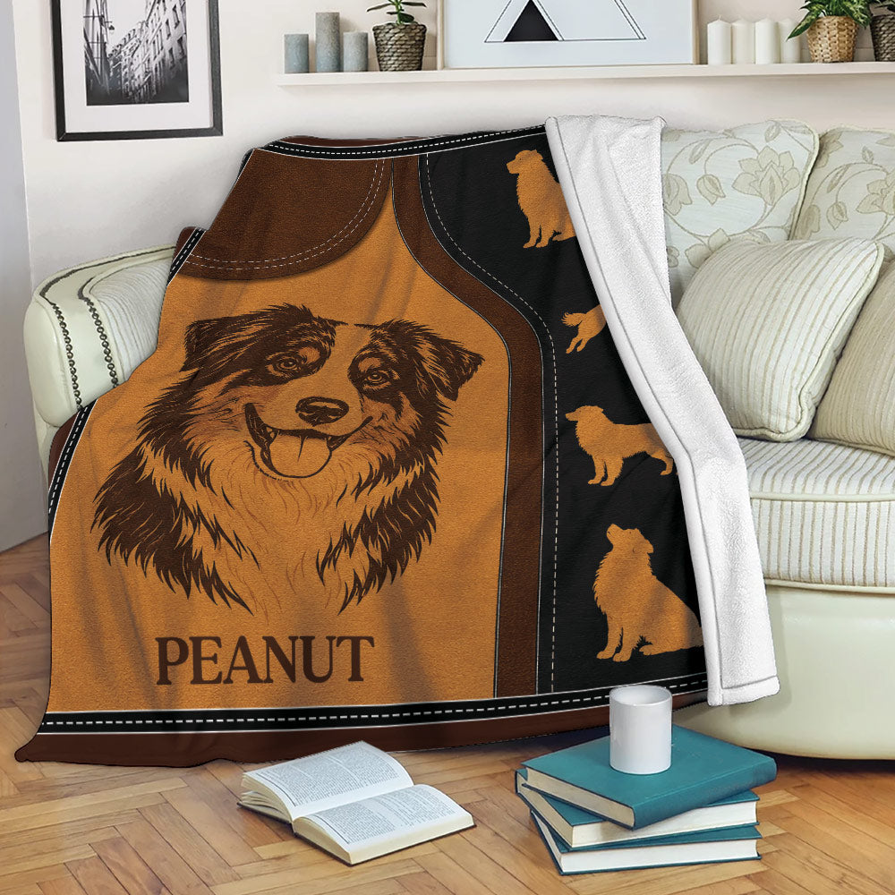 Australian Shepherd blanket displayed on a sofa with rustic dog artwork and cozy living room styling