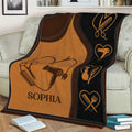 Salon-themed hairstylist blanket draped over a couch with warm brown and black styling tool artwork