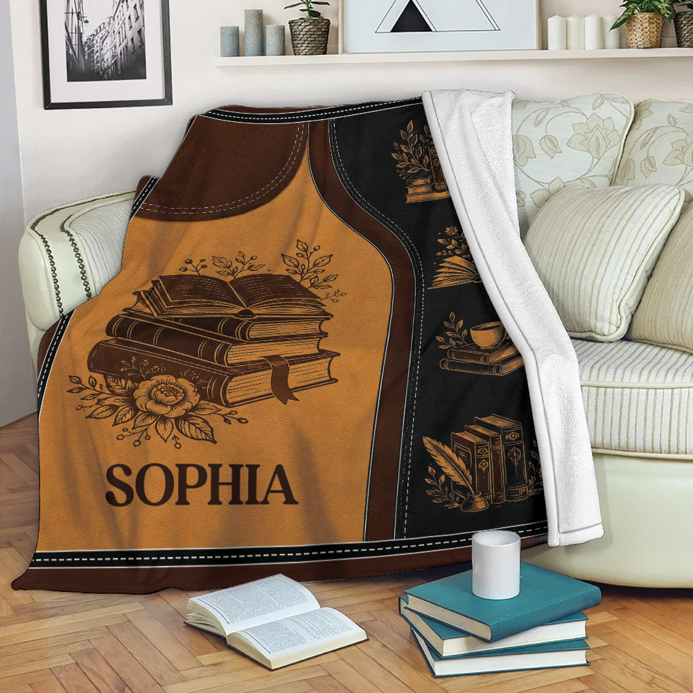 Book throw blanket draped over a sofa with vintage books, reading motifs, and cozy literary artwork