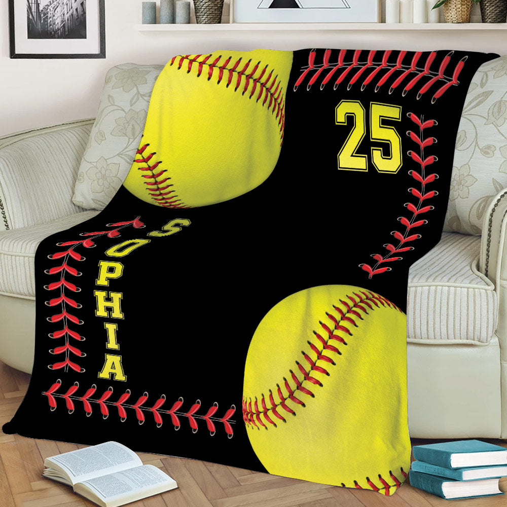Softball throw blanket draped over a couch with bold yellow, red, and black sports artwork