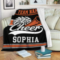 Cheerleading blanket draped over a sofa with pom-pom and megaphone artwork in black and orange