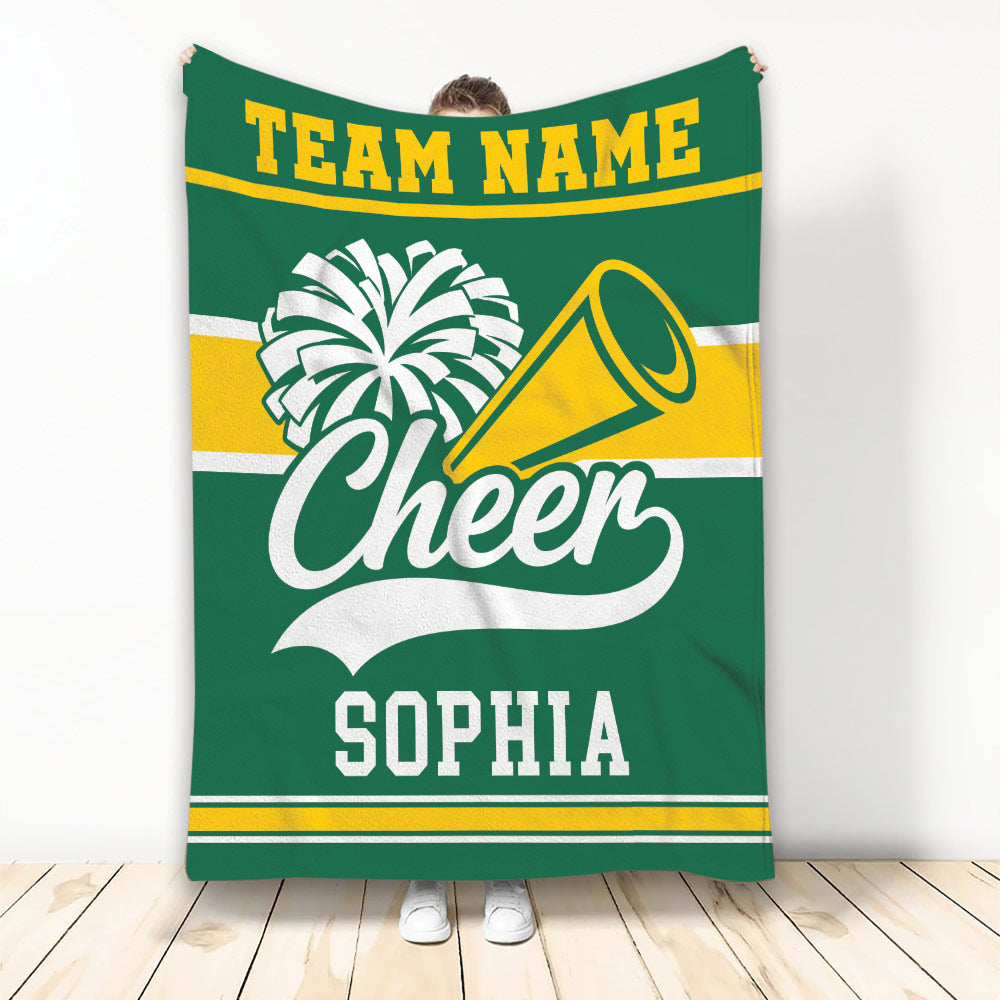 Green cheerleading throw blanket featuring white pom-poms, a megaphone, and gold stripe accents