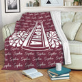 Cheerleading throw blanket styled on a sofa with a megaphone and pom-pom artwork