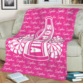 Pink cheerleading throw blanket displayed on a sofa with bold megaphone artwork