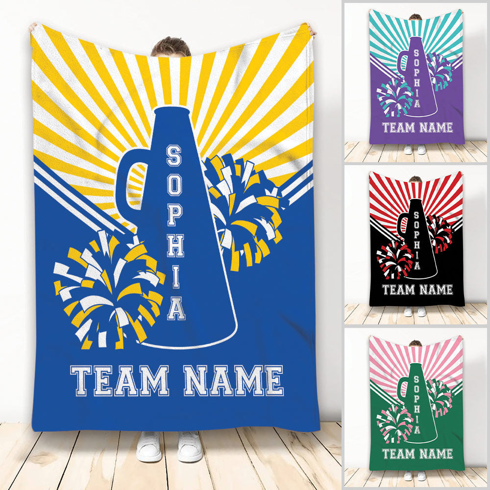 Cheerleading blanket displayed with a megaphone, pom poms, colorful rays, and team-style artwork