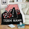 Cheerleading throw blanket draped over a sofa with a megaphone and red, black, and white pom pom design