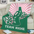 Green and pink cheerleading throw blanket shown on a sofa with megaphone and pom pom artwork
