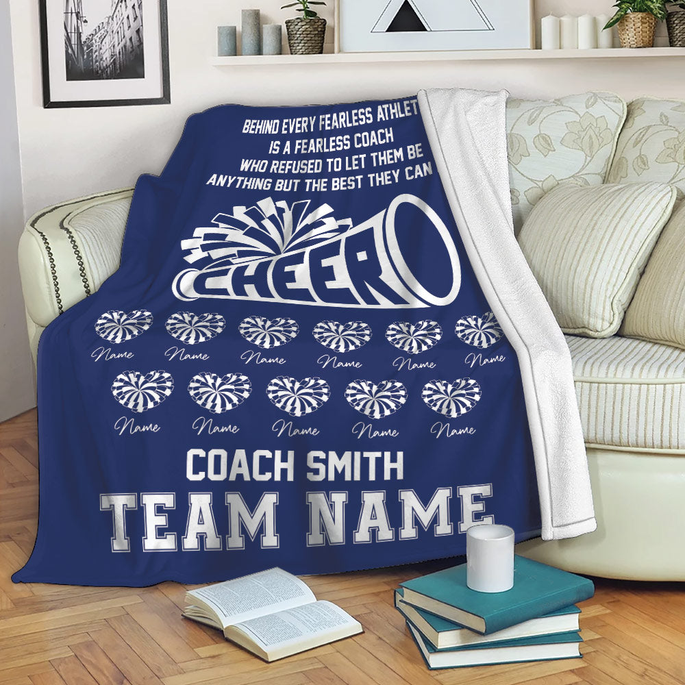Navy cheerleading blanket draped over a sofa with megaphone artwork and coordinated team design