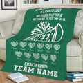 Green cheerleading throw blanket displayed on a sofa with megaphone graphic and team celebration design