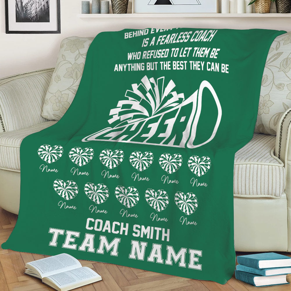 Green cheerleading throw blanket displayed on a sofa with megaphone graphic and team celebration design
