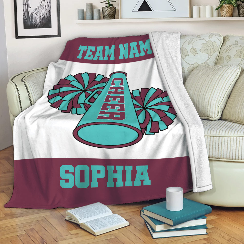 Cheerleading blanket draped over a sofa with colorful pom pom and megaphone artwork