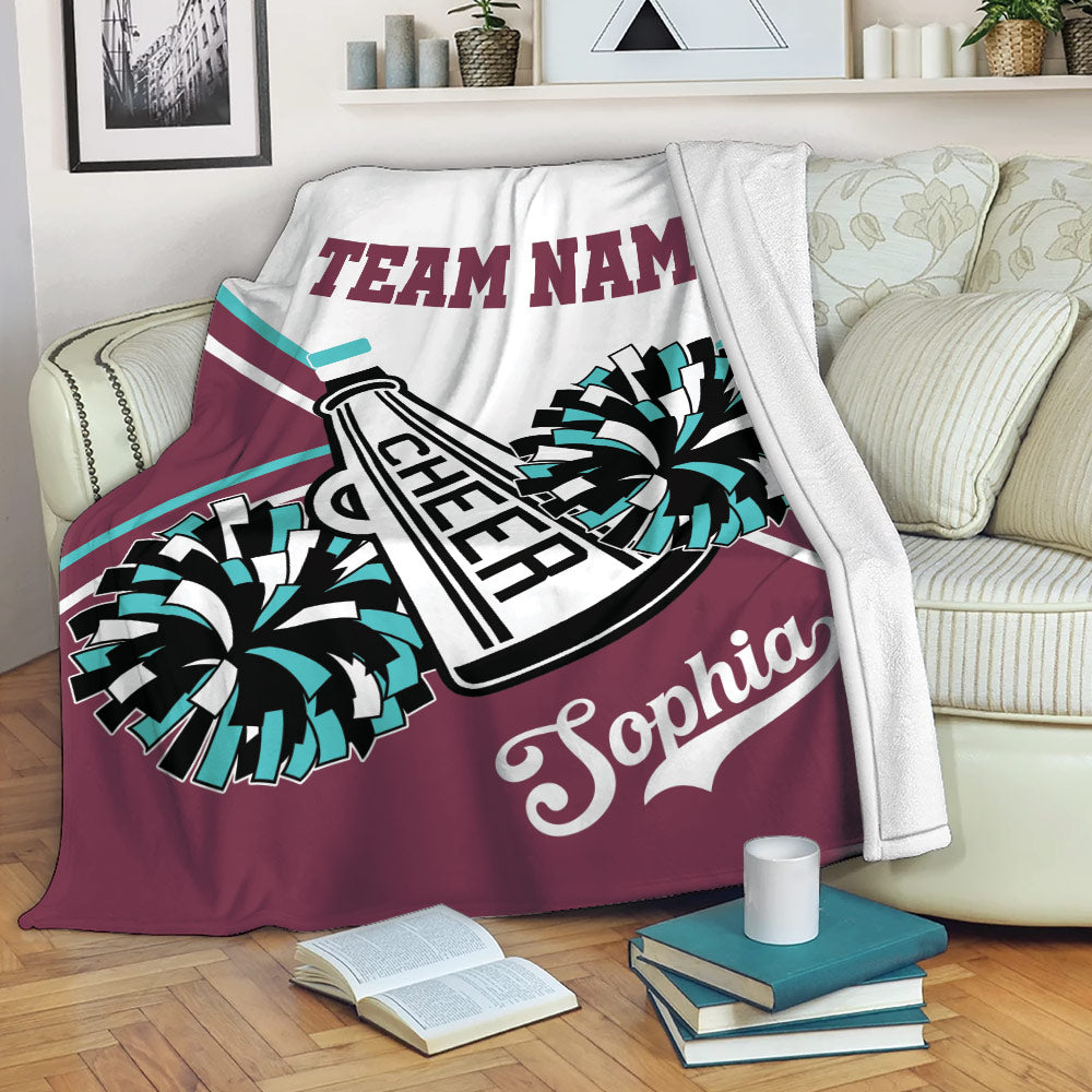 Cheerleading blanket draped over a sofa with colorful pom poms and megaphone artwork