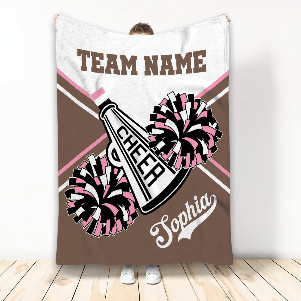 Brown and pink cheerleading blanket featuring pom poms, megaphone artwork, and team graphics