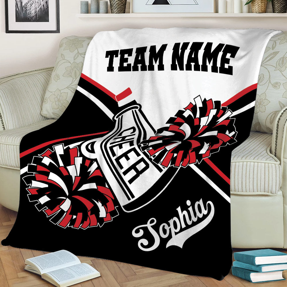Black and red cheerleading throw blanket displayed on a sofa with pom pom artwork