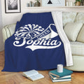 Navy cheerleading throw blanket draped over a sofa with pom-pom and megaphone design