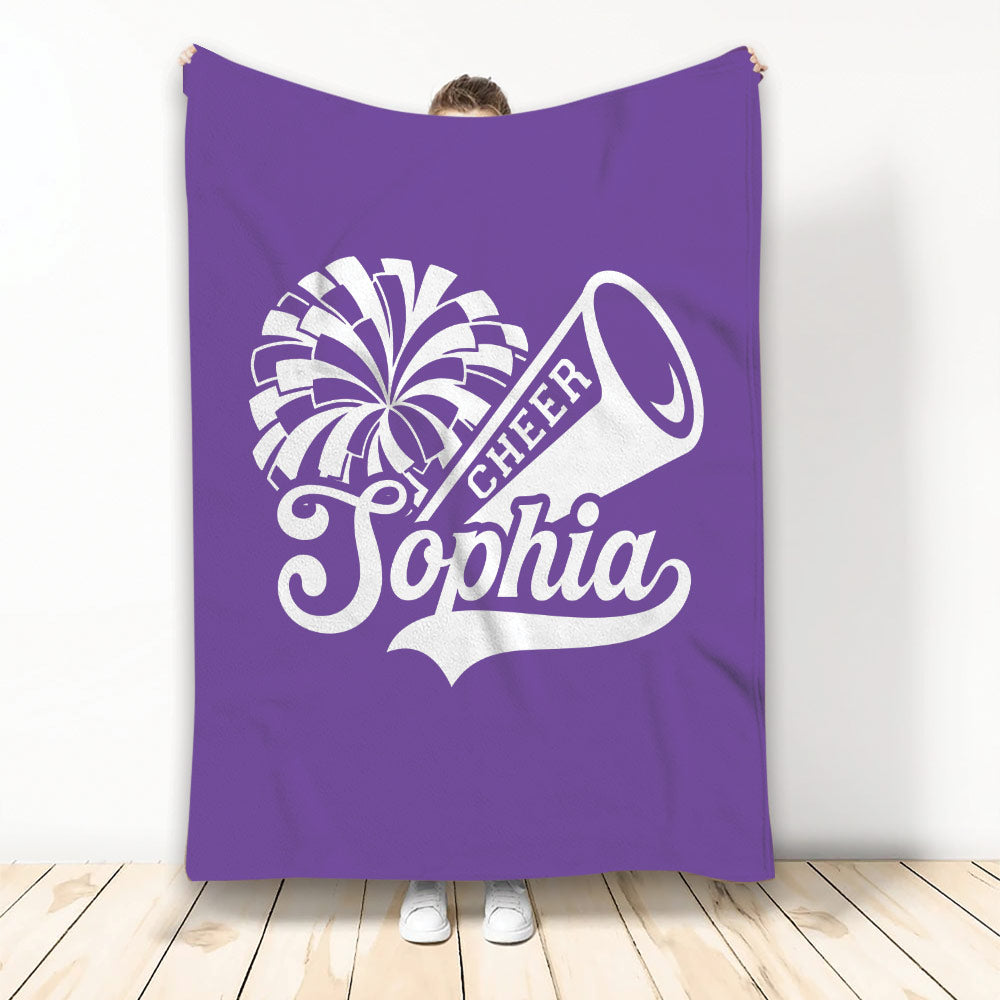 Purple cheerleading throw blanket featuring bold white pom-pom and megaphone artwork