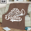 Brown cheerleading throw blanket displayed on a sofa with large white cheer graphic