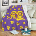 Purple softball throw blanket draped over a sofa with yellow softball heart artwork
