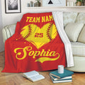 Red softball throw blanket displayed on a sofa with a yellow heart-shaped softball design
