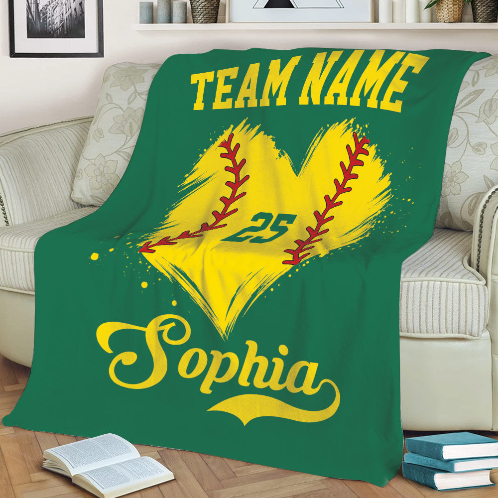 Green softball throw blanket draped over a sofa with a bright yellow softball heart graphic