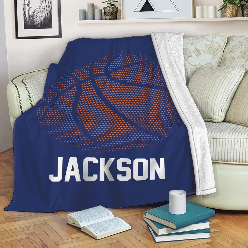 Blue basketball throw blanket draped over a sofa with bold orange dotted ball artwork