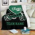 Green cheerleading throw blanket displayed on a sofa with pom-pom and megaphone artwork