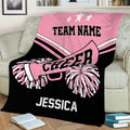 Pink and black cheerleading throw blanket draped over a sofa with pom-pom and megaphone artwork
