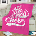 Bright pink cheerleading blanket draped over a sofa with energetic white sports artwork