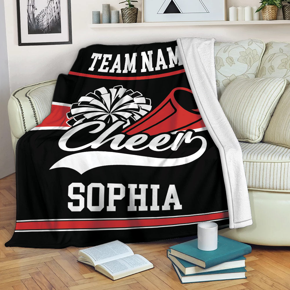 Cheerleading throw blanket draped over a sofa with bold red, black, and white team-inspired artwork