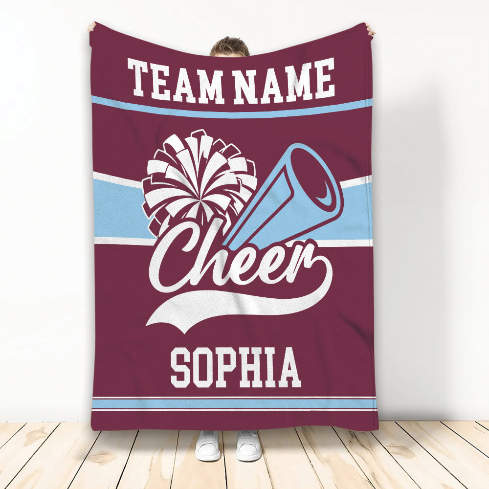 Maroon and light blue cheerleading blanket featuring pom-poms, a megaphone, and bold striped accents