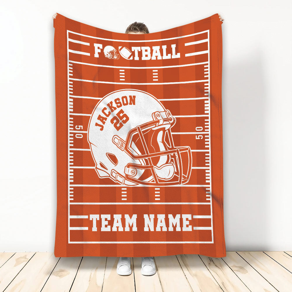 Orange football blanket displayed vertically with a white helmet graphic and athletic field design