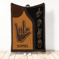 Sign language throw blanket with hand sign artwork in warm brown and black tones