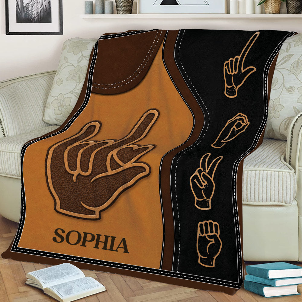 Close view of a sign language throw blanket featuring expressive hand symbols