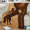 Western cowgirl throw blanket displayed on a sofa with horse and rustic rodeo-inspired artwork
