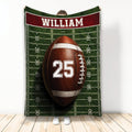 Football throw blanket displayed with an American football on a marked field design