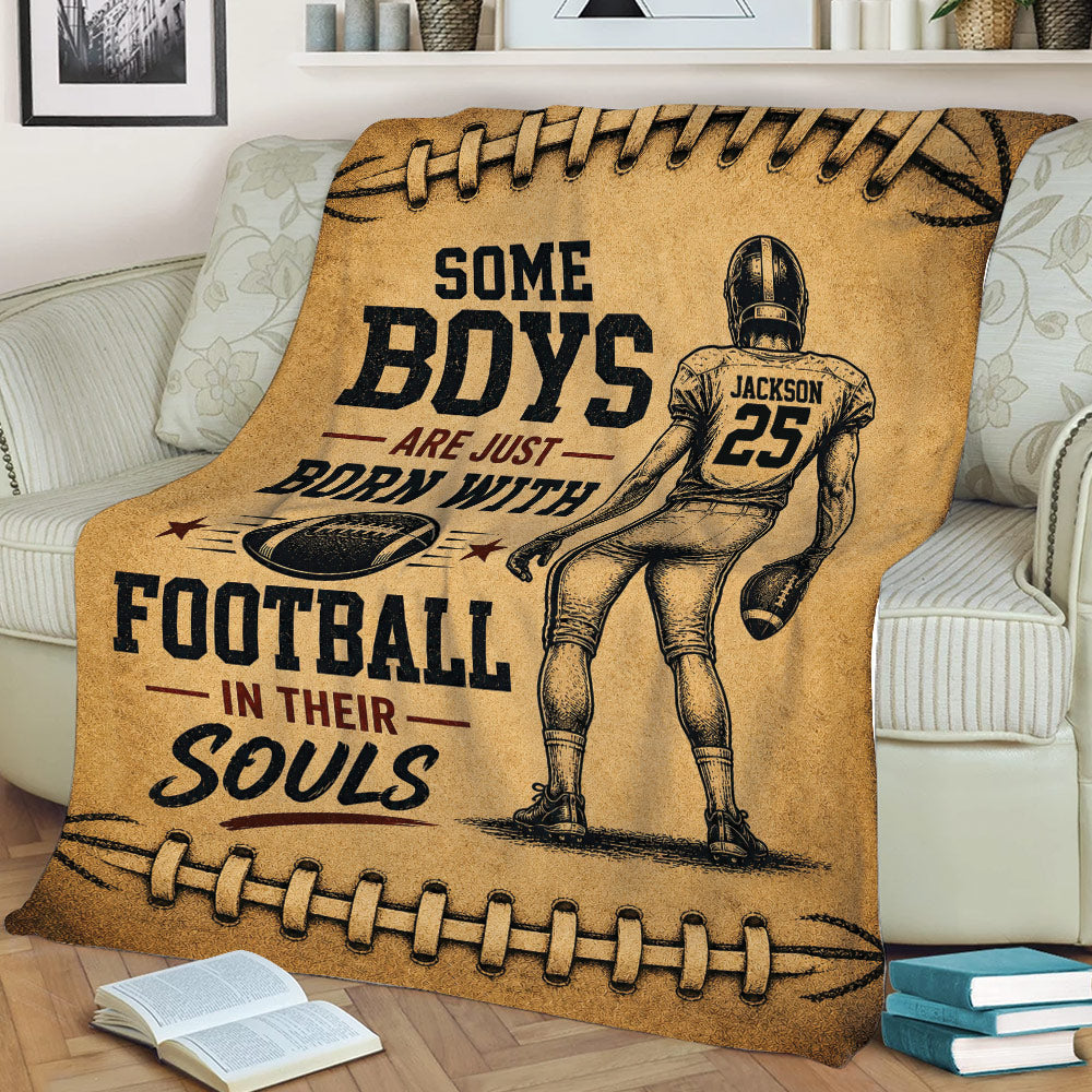 Vintage football blanket displayed on a couch with a helmeted player and football-themed artwork