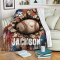 Baseball throw blanket draped over a couch with distressed brick wall and bold sports artwork