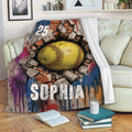 Softball blanket draped over a sofa, showcasing bold brick-breakthrough sports artwork