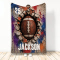 Football throw blanket featuring a dramatic ball breaking through a cracked wall with bold colorful artwork