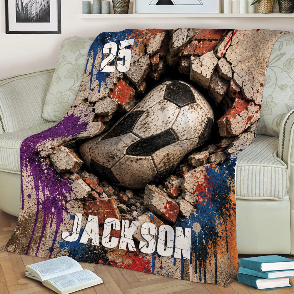 Soccer throw blanket displayed on a couch with dramatic cracked brick and distressed ball artwork