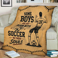 Vintage soccer blanket displayed on a sofa with illustrated player, soccer balls, and distressed sports graphics