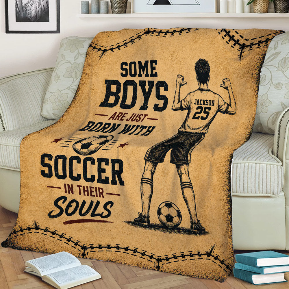 Vintage soccer blanket displayed on a sofa with illustrated player, soccer balls, and distressed sports graphics