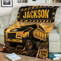 Dump truck blanket styled over a sofa with rugged construction equipment and work-zone artwork